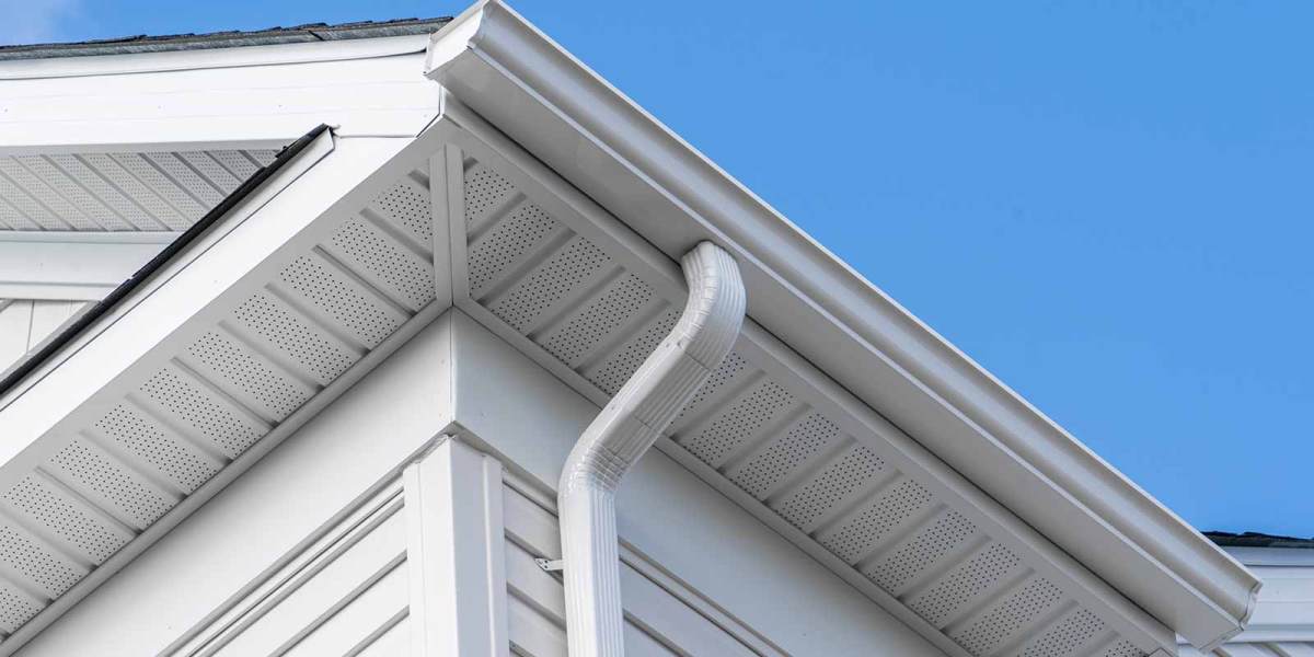 White gutter, downspout and soffit along a house roofline